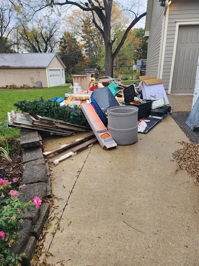Dumpster being loaded with debris for 12 Yard Dumpster Rental in Rye Brook